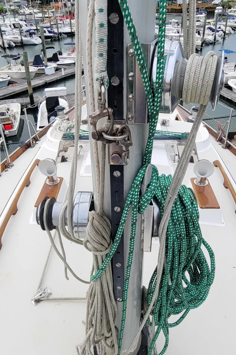 Slide: The Image of 1985 Bristol 38.8 sailboat deck view, docked in a marina with surrounding boats. - 9