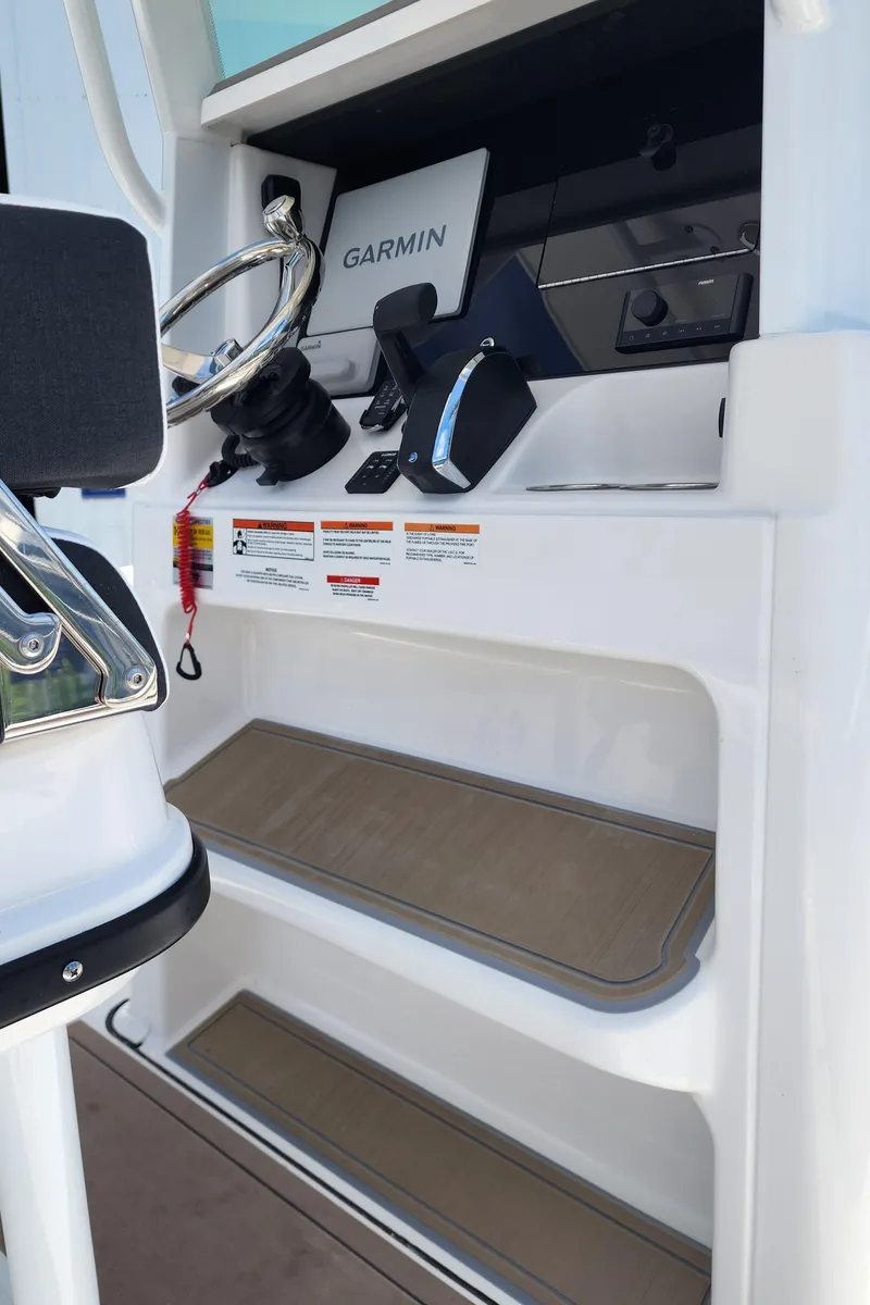 Slide: The Image of Interior helm of 2026 Blackfin 242HB boat with Garmin navigation system. - 11