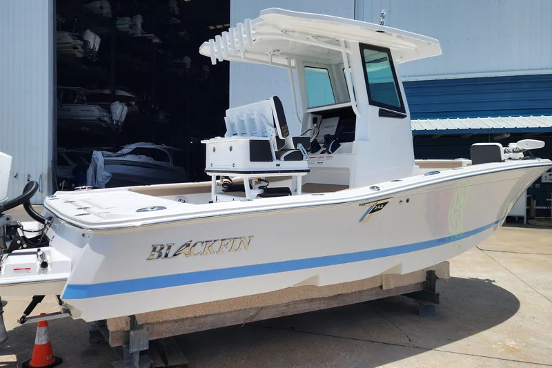 Slide: The Image of 2026 Blackfin 242HB boat in a marina, showcasing sleek design and modern features. - 5