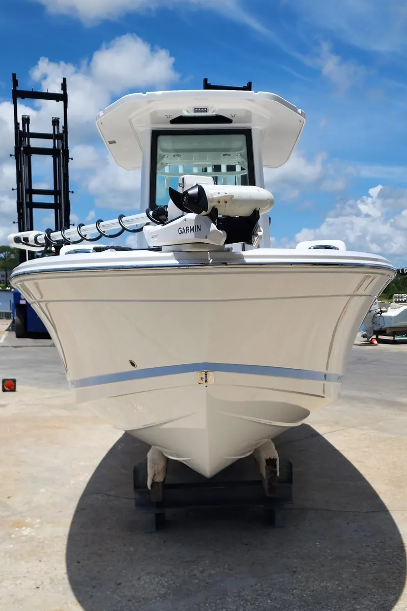 Slide: The Image of 2026 Blackfin 242HB boat with Garmin equipment, docked under a clear blue sky. - 9