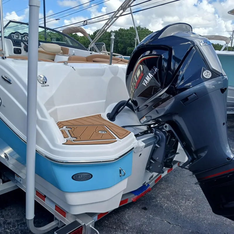Slide: The Image of 2025 NauticStar 243 DC Deck boat with Yamaha outboard motor, displayed on a trailer. - 3