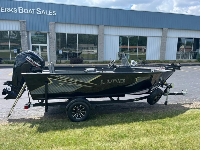 Slide: The Image of 2026 Lund 1675 Adventure SS boat on trailer outside dealership. - 1