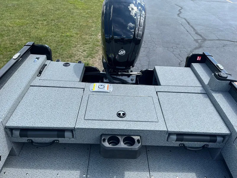 Slide: The Image of 2026 Lund 1675 Adventure SS boat interior with motor, gray deck, and storage compartments. - 10