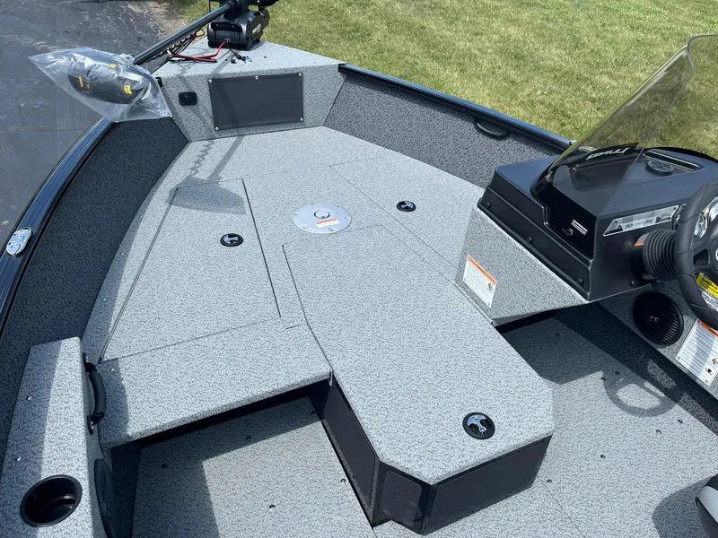 Slide: The Image of 2026 Lund 1675 Adventure SS boat interior with steering console and spacious deck. - 11