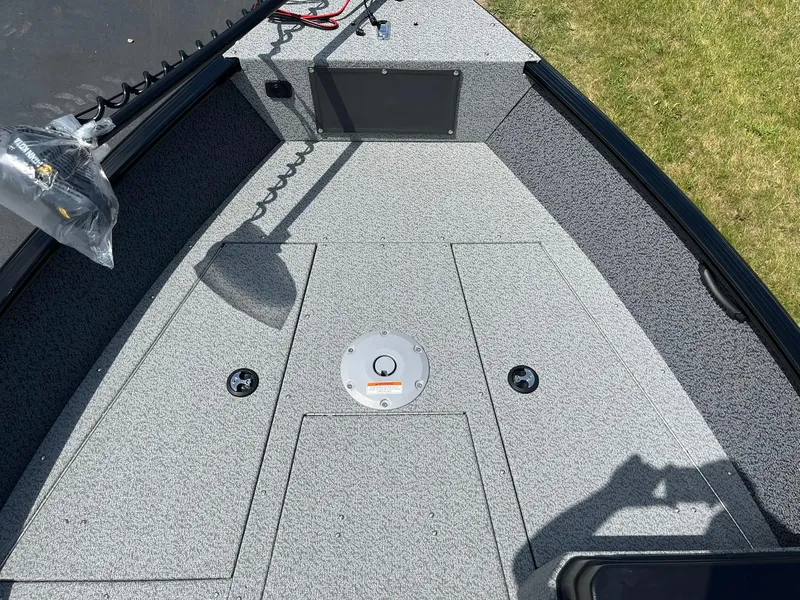 Slide: The Image of 2026 Lund 1675 Adventure SS boat deck with storage compartments and control panel. - 13