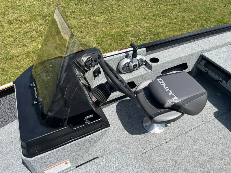Slide: The Image of 2026 Lund 1675 Adventure SS boat interior with steering console and seat. - 15