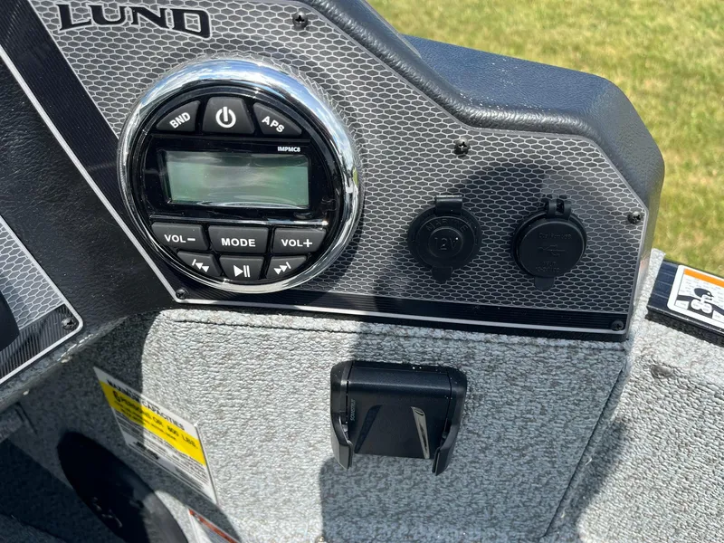 Slide: The Image of Control panel of 2026 Lund 1675 Adventure SS boat with audio system and power outlets. - 16