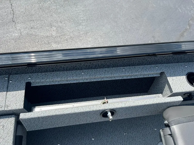 Slide: The Image of Interior view of 2026 Lund 1675 Adventure SS boat, featuring storage compartment and seating. - 20