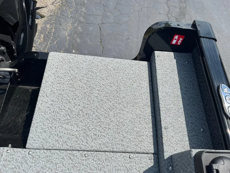 Slide: The Image of 2026 Lund 1675 Adventure SS boat deck with textured surface and safety sticker. - 21