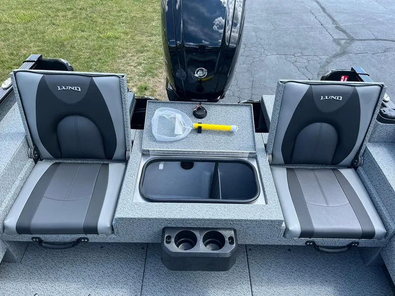 Slide: The Image of 2026 Lund 1675 Adventure SS boat interior with two seats and fishing gear. - 8