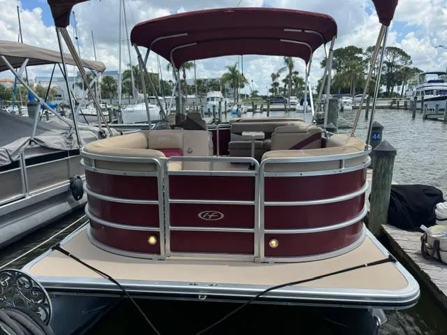 The Image of 2014 Harris FloteBote Cruiser 200 pontoon boat docked at marina. - 0