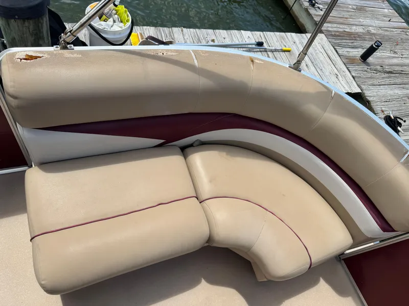 Slide: The Image of 2014 Harris FloteBote Cruiser 200 boat seat with beige and maroon upholstery, dockside view. - 3