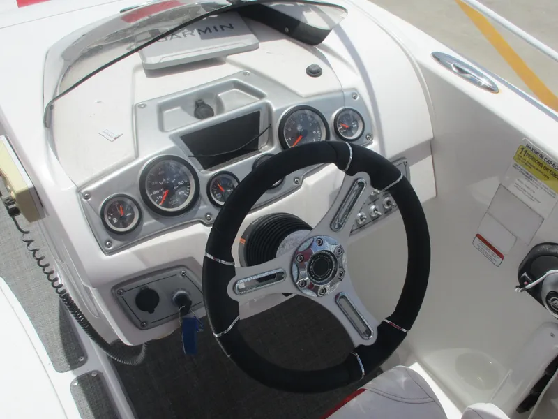 Slide: The Image of 2019 Tahoe 2150 boat dashboard with steering wheel and gauges. - 17