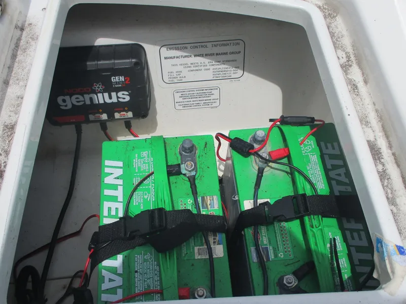Slide: The Image of 2019 Tahoe 2150 boat battery compartment with NOCO Genius charger and Interstate batteries. - 19
