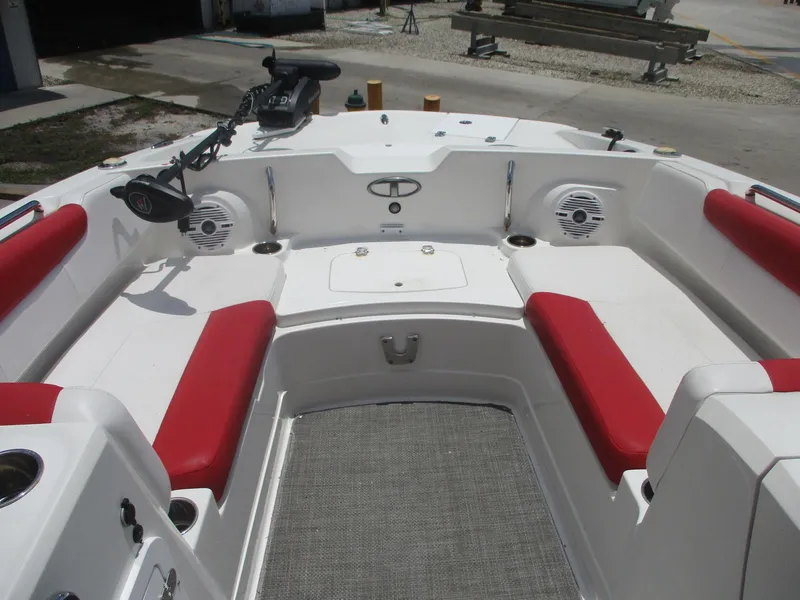 Slide: The Image of 2019 Tahoe 2150 boat interior with red seating and fishing equipment. - 2
