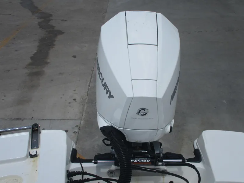 Slide: The Image of 2019 Tahoe 2150 boat with Mercury outboard motor in a concrete area. - 21