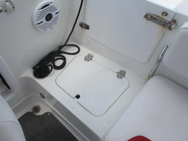 Slide: The Image of 2019 Tahoe 2150 boat interior with speaker, storage hatch, and rope. - 24