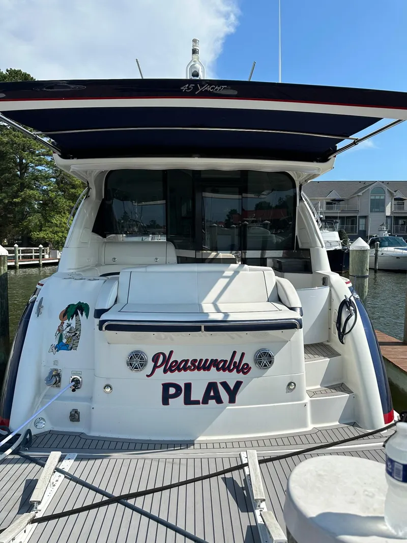 Slide: The Image of 2017 Formula 45 Yacht docked, rear view with "Pleasurable Play" name visible. - 11