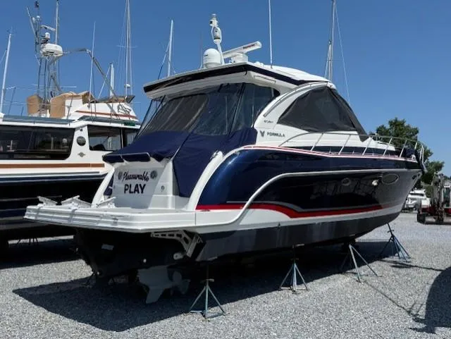 Slide: The Image of 2017 Formula 45 Yacht on stands, blue and white design, marina background. - 3