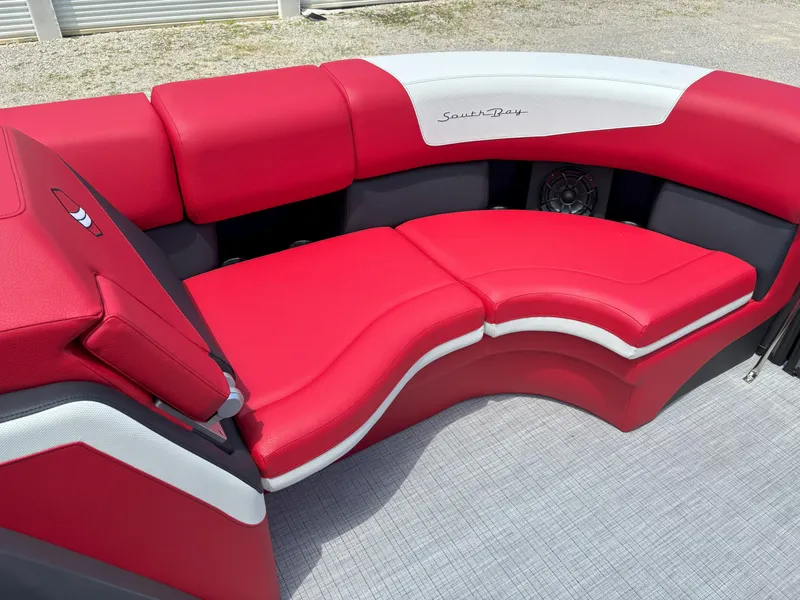 Slide: The Image of Red and white seating on 2026 South Bay 523 RS-DC boat, featuring modern design. - 11