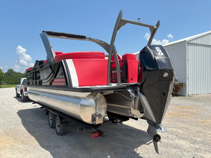 Slide: The Image of 2026 South Bay 523 RS-DC pontoon boat with red seating and powerful outboard motor. - 3