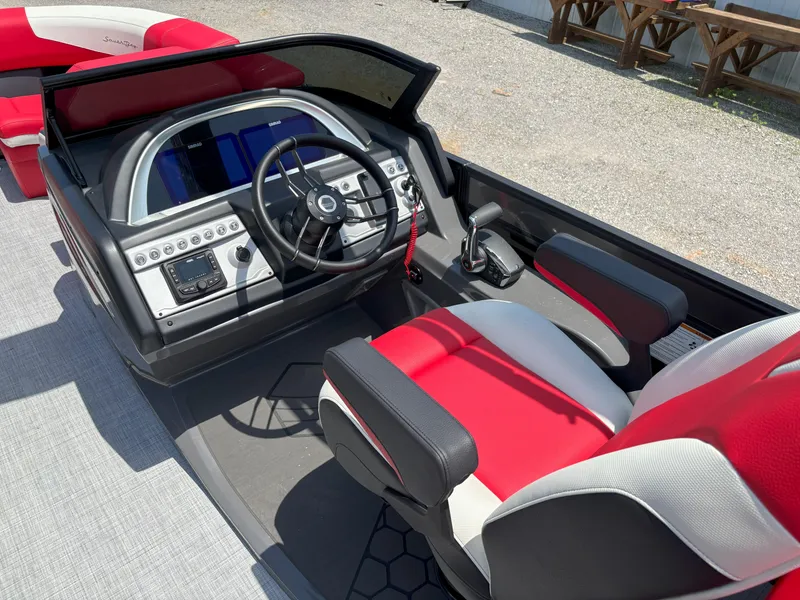 Slide: The Image of 2026 South Bay 523 RS-DC boat cockpit with red and white seating, modern controls. - 7