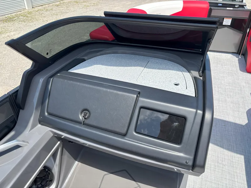 Slide: The Image of 2026 South Bay 523 RS-DC boat dashboard with storage compartment and windshield. - 8