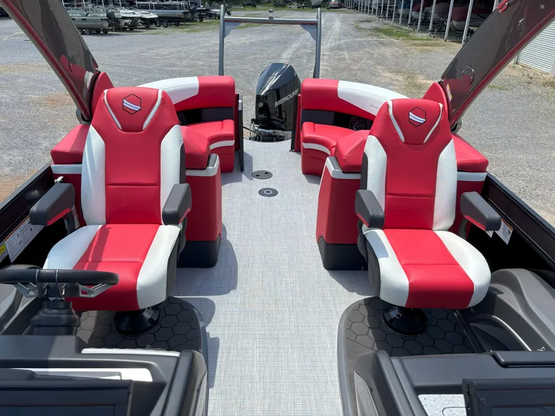 Slide: The Image of 2026 South Bay 523 RS-DC boat interior with red and white seating, steering wheel, and outboard motor. - 9