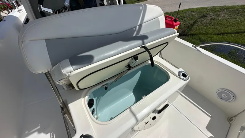 Slide: The Image of 2016 Boston Whaler 240 Dauntless boat with open storage compartment and seating. - 10