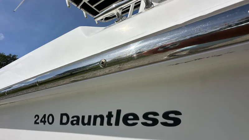 Slide: The Image of 2016 Boston Whaler 240 Dauntless boat, close-up of model name and chrome detail. - 4
