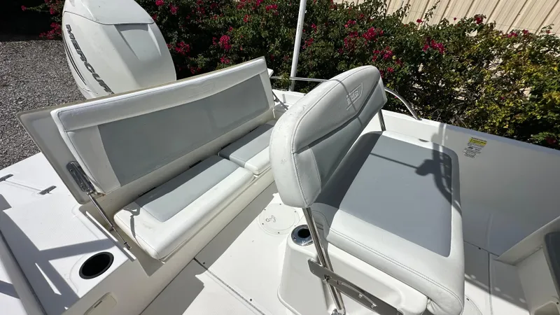 Slide: The Image of 2016 Boston Whaler 240 Dauntless boat seating area with Mercury engine. - 9
