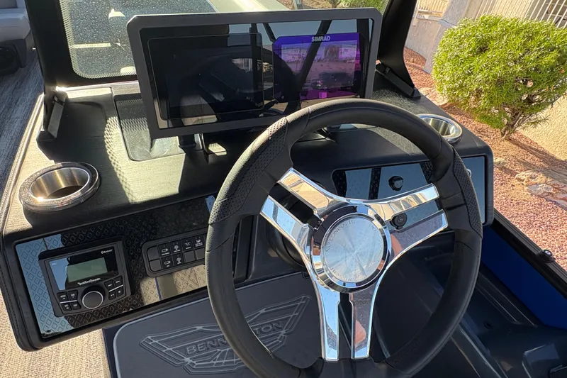 Slide: The Image of 2026 Bennington 26 MSB boat dashboard with steering wheel and digital display. - 10
