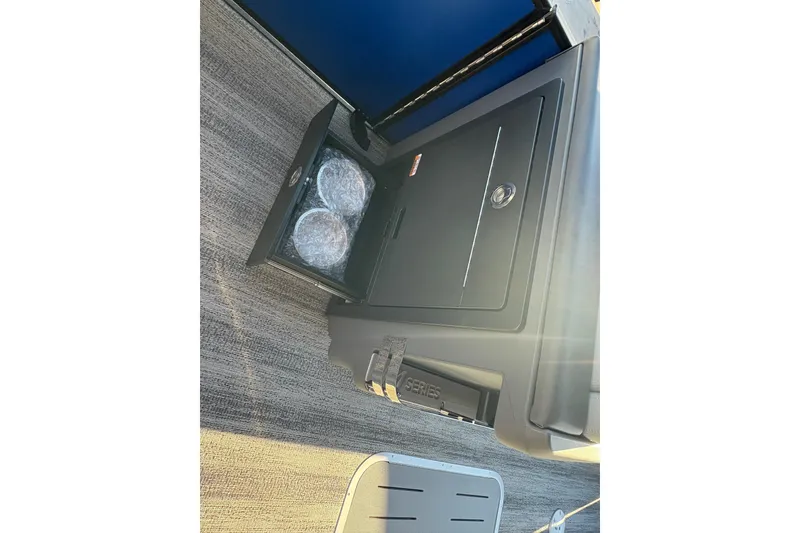 Slide: The Image of Storage compartment on 2026 Bennington 26 MSB boat with wrapped items inside. - 16