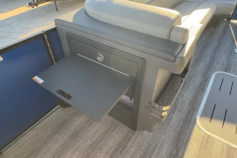 Slide: The Image of 2026 Bennington 26 MSB boat interior with fold-out table and cushioned seating. - 17