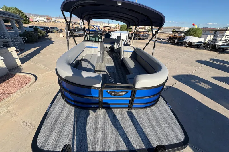 Slide: The Image of 2026 Bennington 26 MSB pontoon boat with blue exterior and spacious seating. - 5
