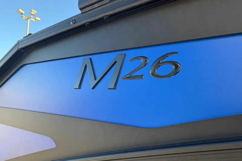 Slide: The Image of Close-up of 2026 Bennington 26 MSB boat model emblem on blue background. - 6