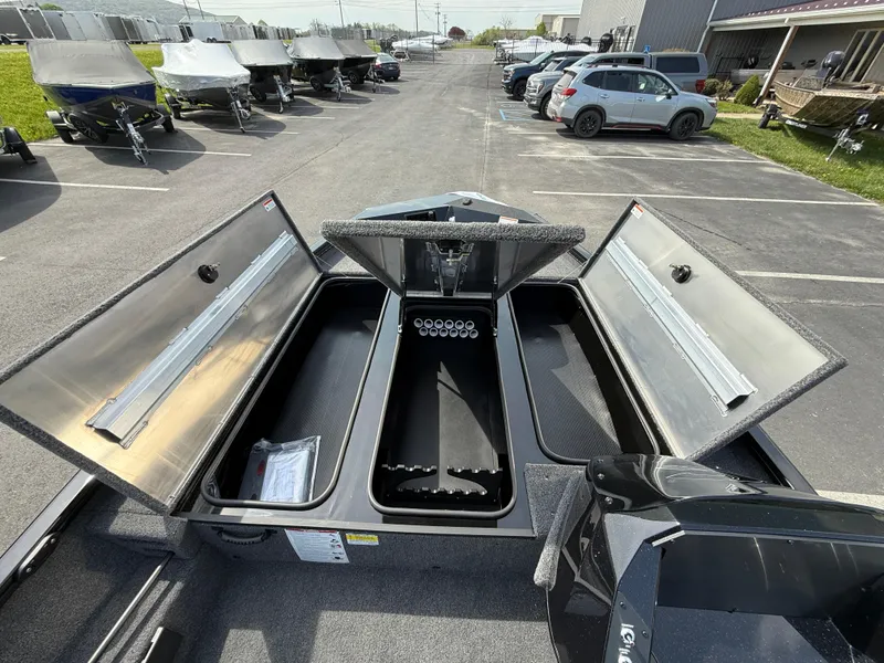 Slide: The Image of 2025 Crestliner XF 189 boat with open storage compartments in a parking lot. - 5