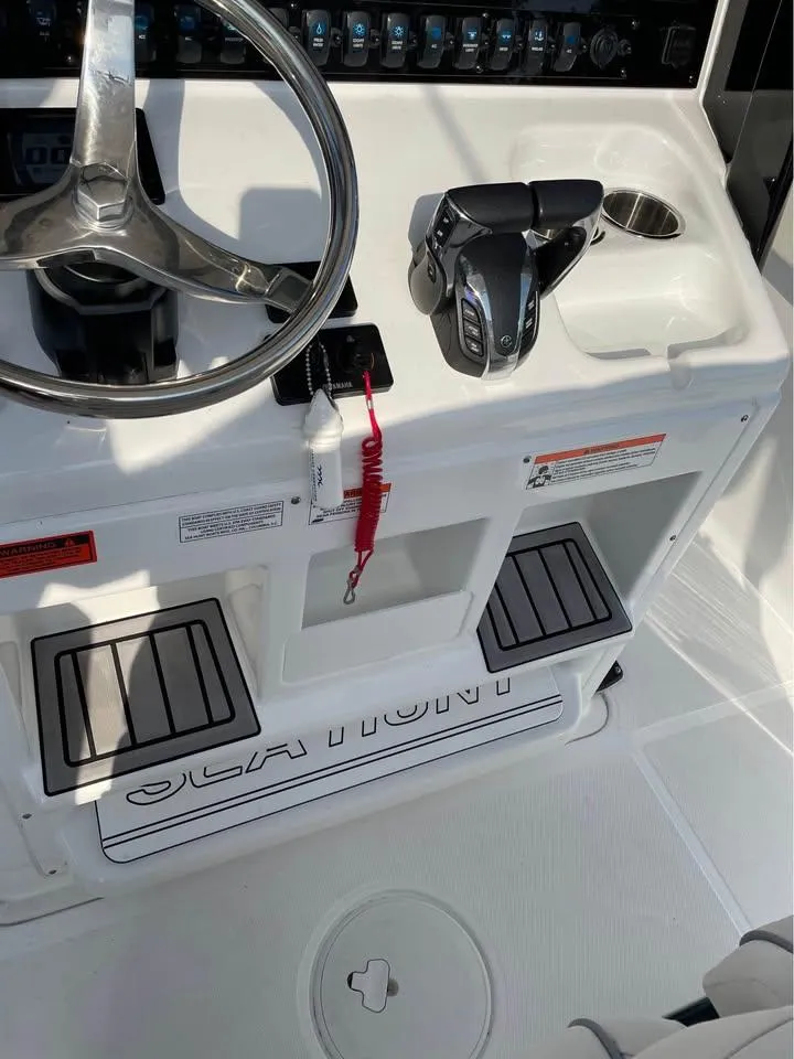 Slide: The Image of 2023 Sea Hunt Ultra 265 SE boat console with steering wheel and controls. - 3
