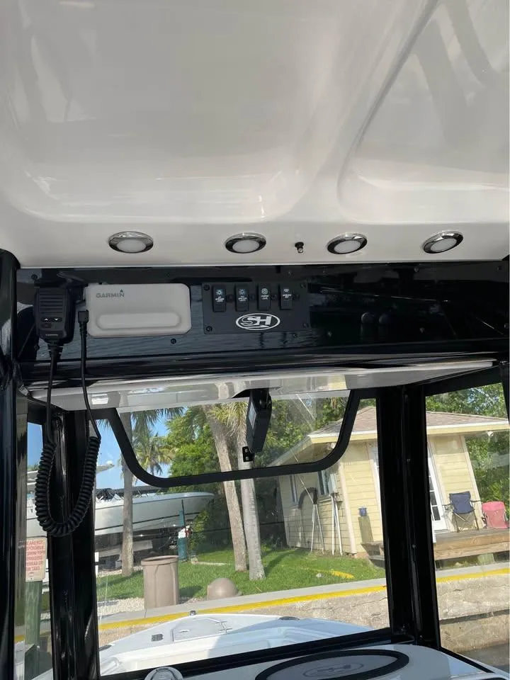 Slide: The Image of 2023 Sea Hunt Ultra 265 SE boat dashboard with Garmin device and control panel. - 9