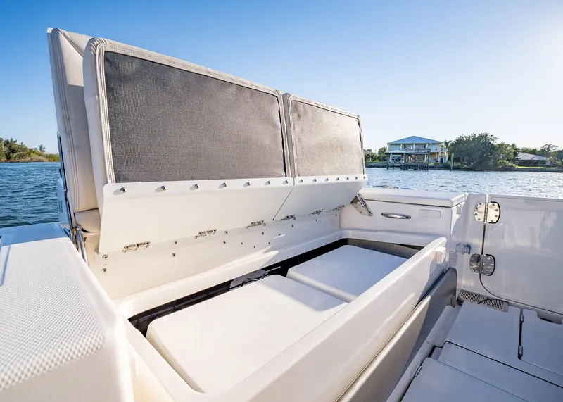 Slide: The Image of 2025 Solace 30 CS boat with open storage compartment, scenic waterfront view. - 17