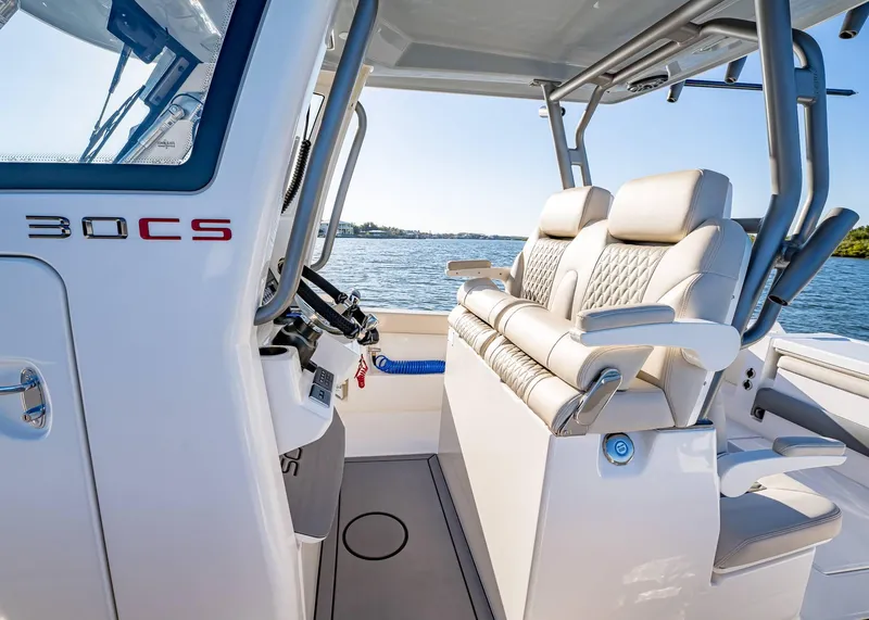Slide: The Image of Interior of 2025 Solace 30 CS boat with luxurious seating and steering console. - 28