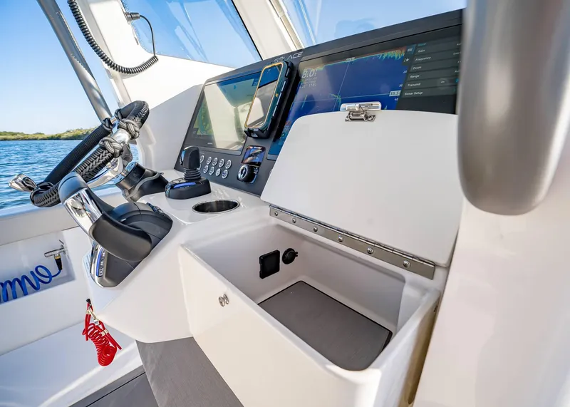 Slide: The Image of 2025 Solace 30 CS boat helm with advanced navigation controls and display. - 31