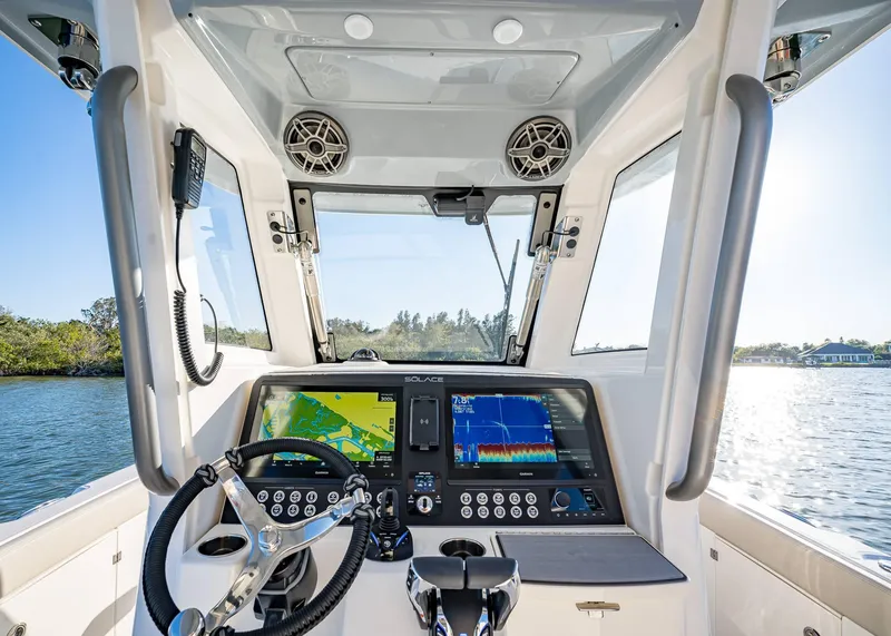 Slide: The Image of 2025 Solace 30 CS boat cockpit with advanced navigation system and steering wheel. - 33