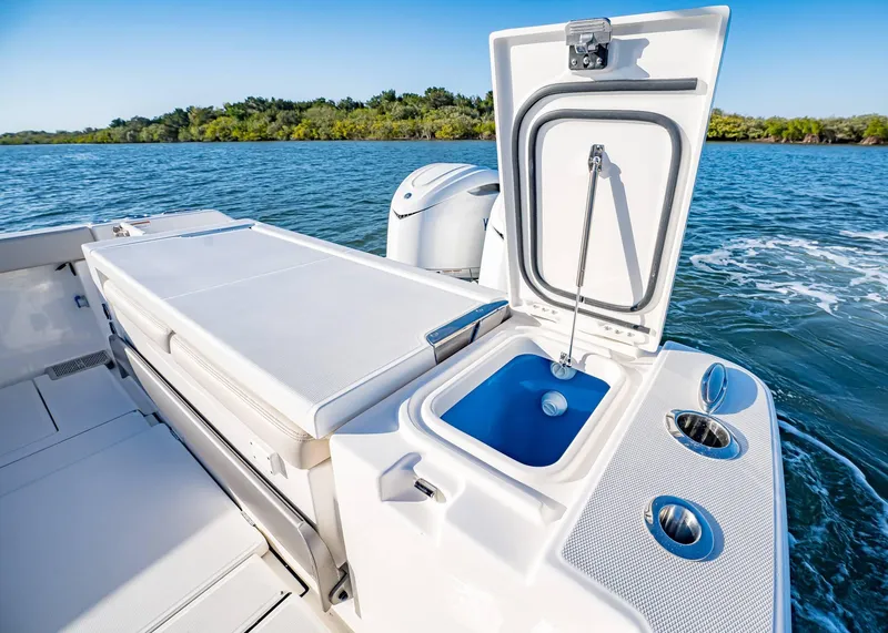 Slide: The Image of 2025 Solace 30 CS boat with open storage compartment on a sunny day. - 6