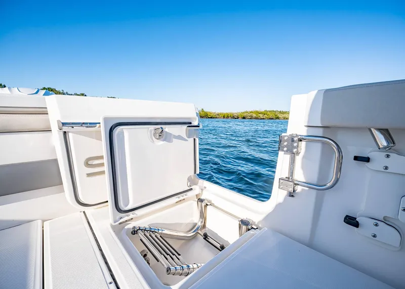 Slide: The Image of 2025 Solace 30 CS boat with open hatch, ladder, and scenic water view. - 9