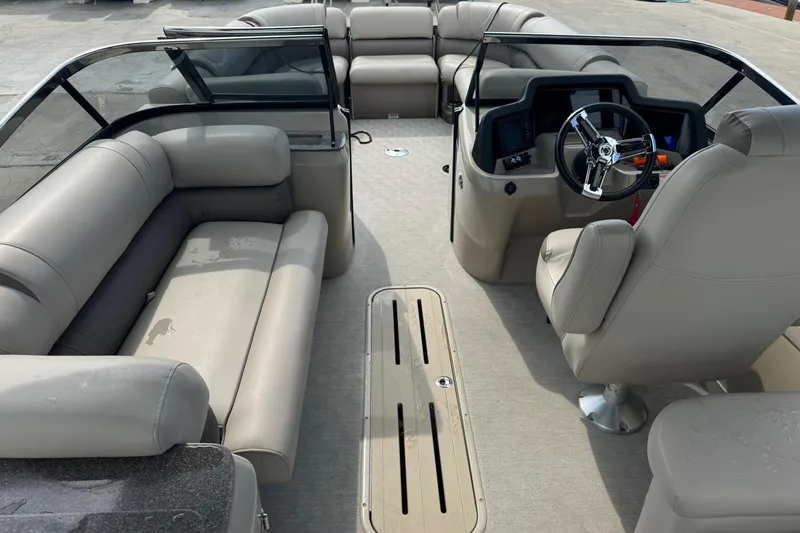 Slide: The Image of 2017 Tahoe Pontoon Cascade Platinum 2785EL interior with beige seating and steering console. - 12