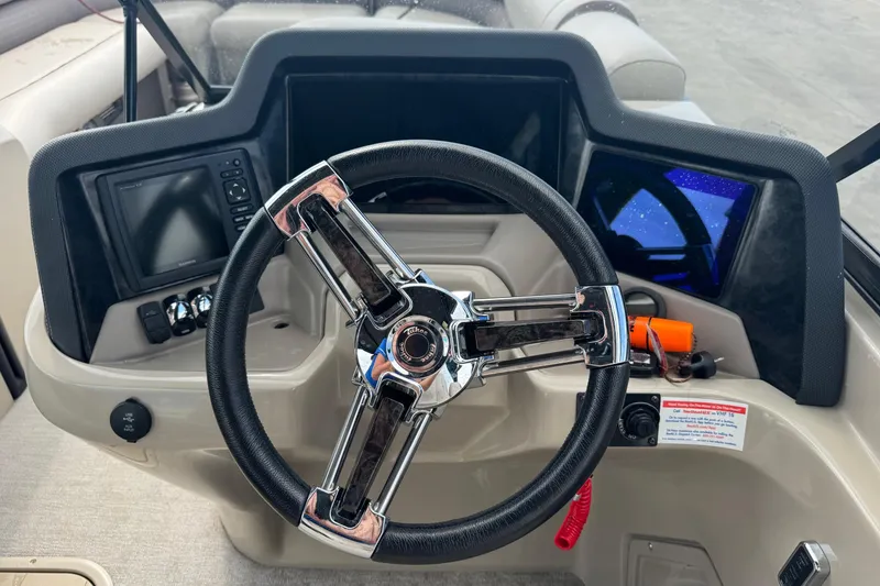 Slide: The Image of Steering console of 2017 Tahoe Pontoon Cascade Platinum 2785EL with modern controls and displays. - 16