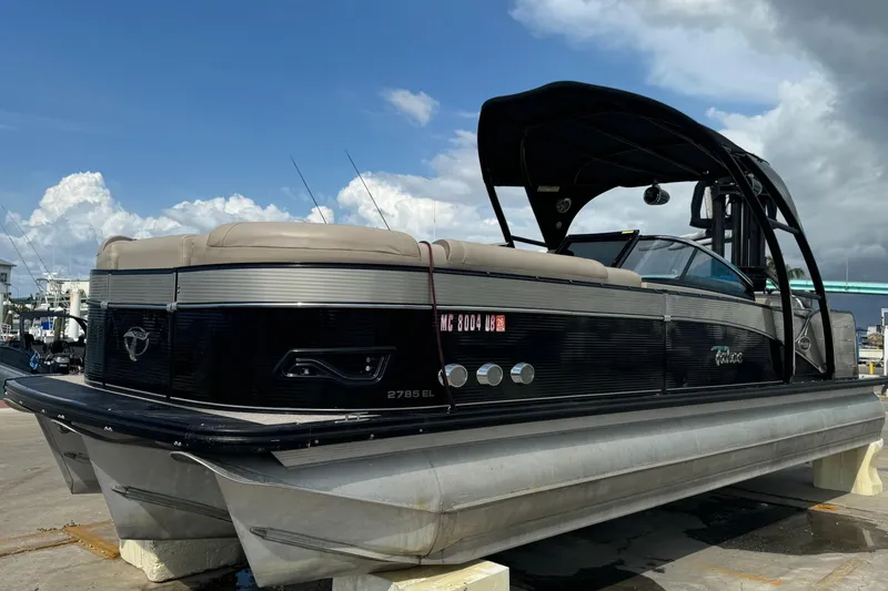 Slide: The Image of 2017 Tahoe Pontoon Cascade Platinum 2785EL on display under a cloudy sky. - 25