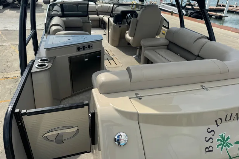 Slide: The Image of 2017 Tahoe Pontoon Cascade Platinum 2785EL interior with seating and helm, docked at marina. - 4