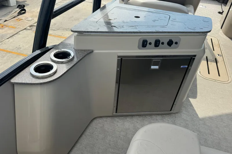 Slide: The Image of 2017 Tahoe Pontoon Cascade Platinum 2785EL interior with cup holders and storage cabinet. - 5